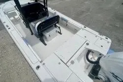 Slide: The Image of 2025 Robalo 266 Cayman SD boat interior with seating and storage compartments. - 14