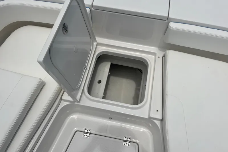 Slide: The Image of 2025 Robalo 266 Cayman SD boat storage compartment with open hatch. - 17