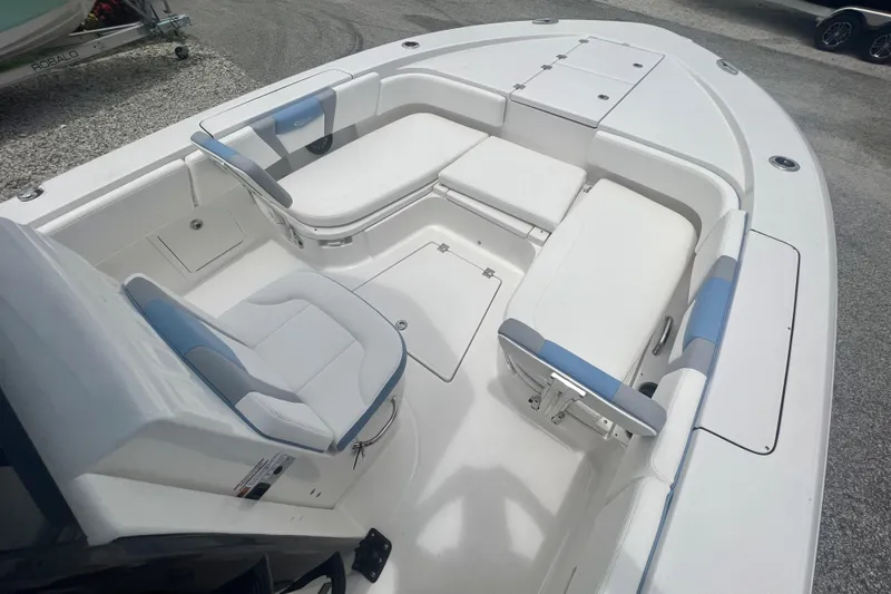 Slide: The Image of 2025 Robalo 266 Cayman SD boat interior with white and blue seating. - 21
