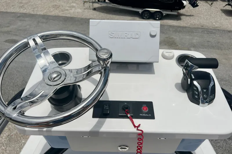 Slide: The Image of 2025 Robalo 266 Cayman SD helm with steering wheel and control panel. - 26