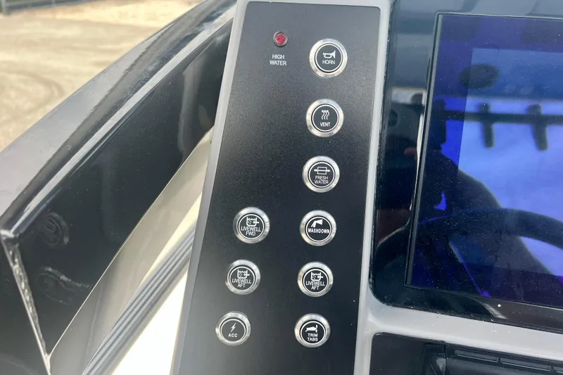 Slide: The Image of Control panel of 2025 Robalo 266 Cayman SD boat with various function buttons. - 31