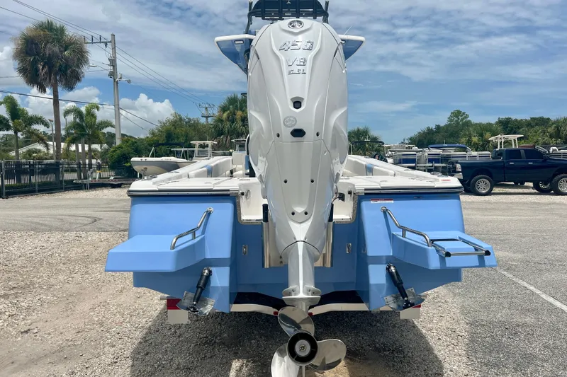Slide: The Image of 2025 Robalo 266 Cayman SD boat with powerful V8 engine, parked outdoors. - 5