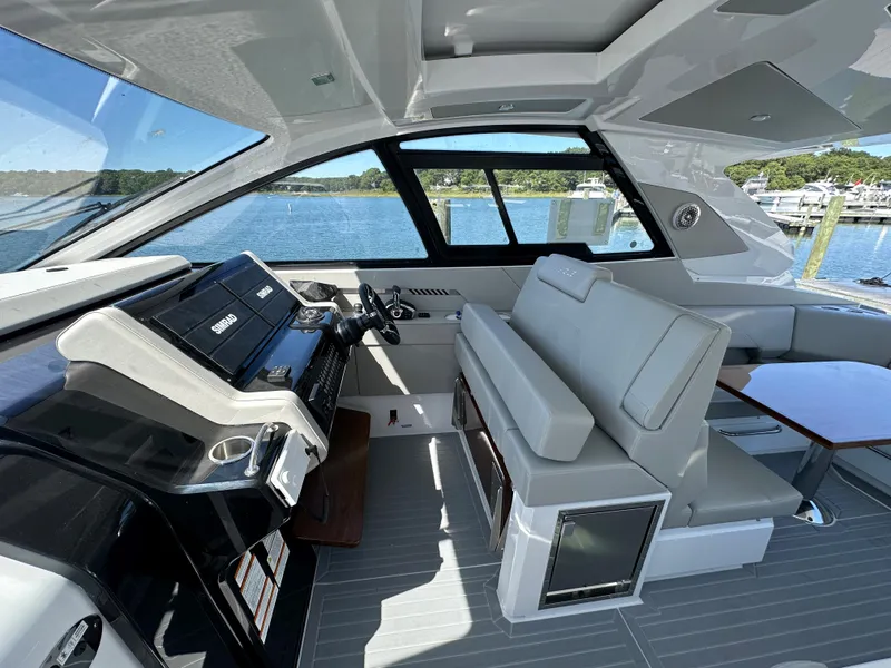 Slide: The Image of 2024 Cruisers Yachts 42 GLS Outboard interior with helm and seating area. - 18