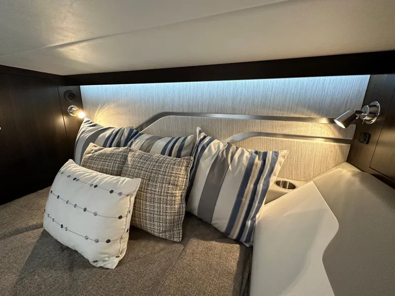 Slide: The Image of 2024 Cruisers Yachts 42 GLS Outboard cabin with stylish pillows and modern lighting. - 29
