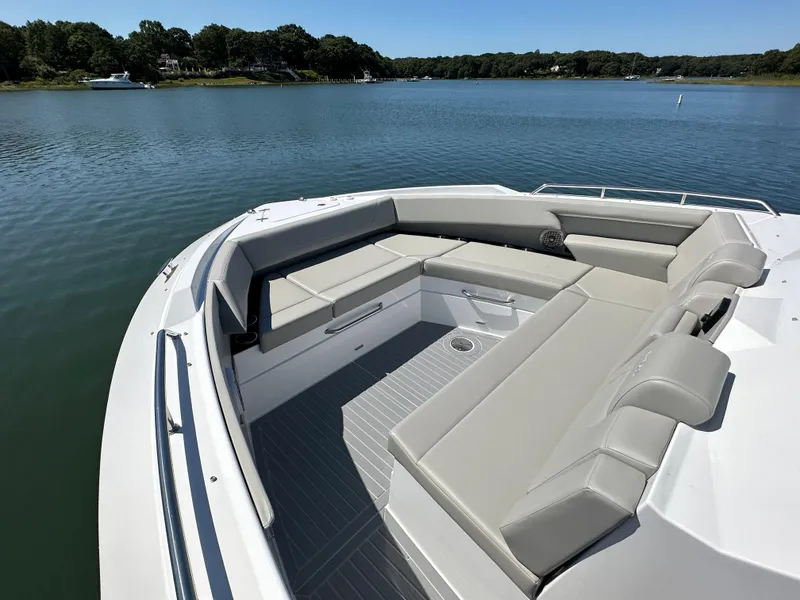Slide: The Image of 2024 Cruisers Yachts 42 GLS Outboard, spacious seating area on calm water. - 31