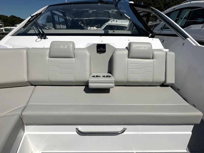 Slide: The Image of 2024 Cruisers Yachts 42 GLS Outboard, luxurious seating area with cup holders. - 33