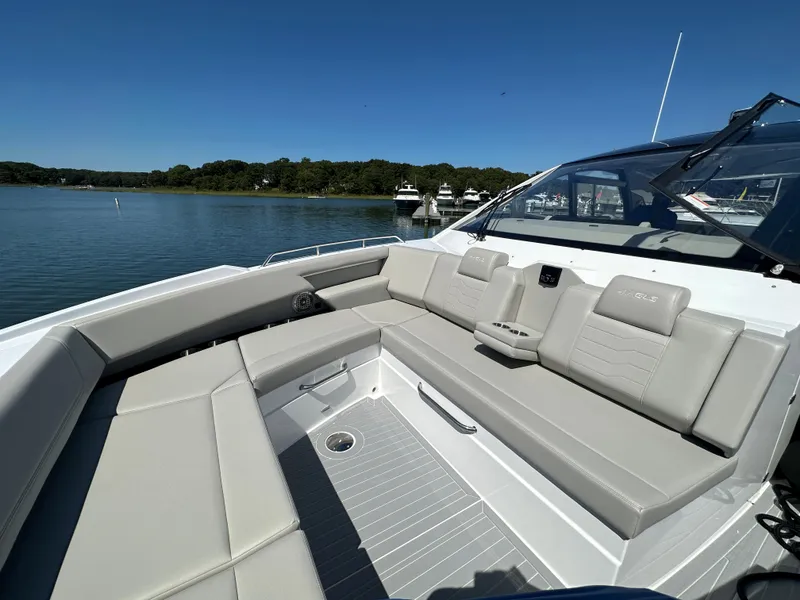 Slide: The Image of 2024 Cruisers Yachts 42 GLS Outboard with spacious seating on a serene lake. - 34