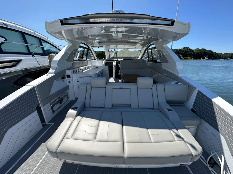 Slide: The Image of 2024 Cruisers Yachts 42 GLS Outboard, luxury boat interior with spacious seating. - 9