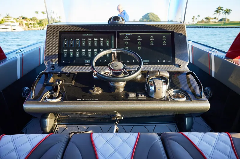 Slide: The Image of Cockpit of 2020 Midnight Express 37 Open boat with modern controls and steering wheel. - 13