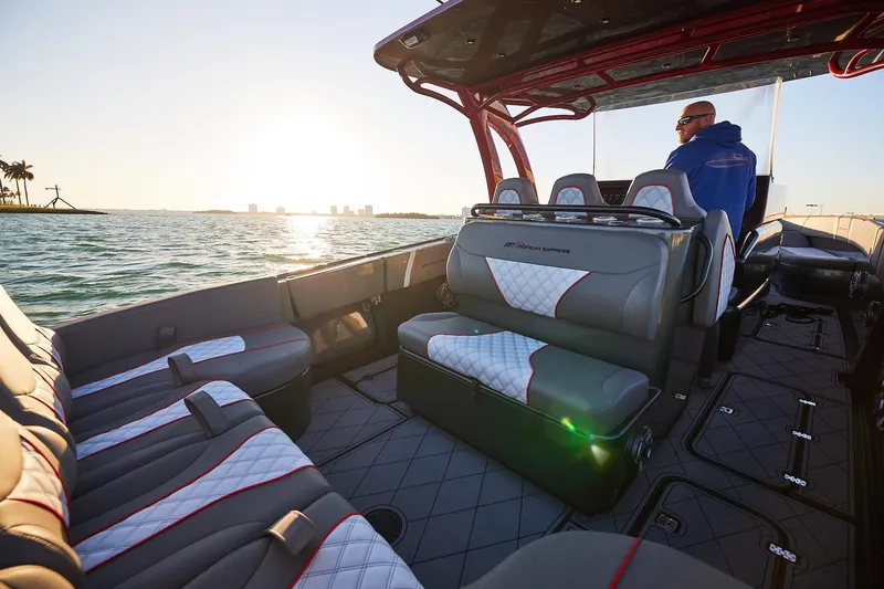 Slide: The Image of 2020 Midnight Express 37 Open boat interior with luxurious seating at sunset on the water. - 15