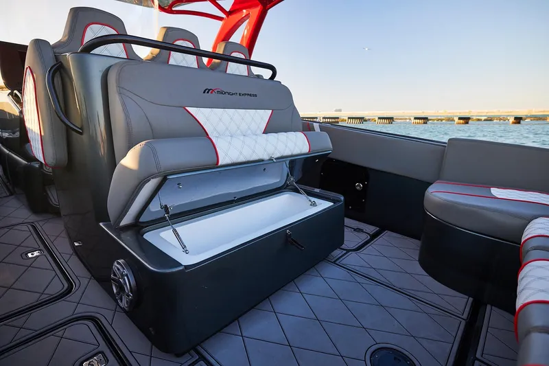 Slide: The Image of Luxury seating on 2020 Midnight Express 37 Open boat with storage compartment open. - 16