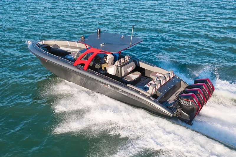 Slide: The Image of 2020 Midnight Express 37 Open boat cruising on the ocean with multiple outboard engines. - 2