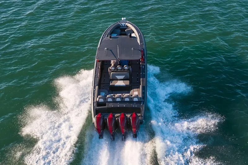 Slide: The Image of 2020 Midnight Express 37 Open boat cruising on open water, rear view. - 3