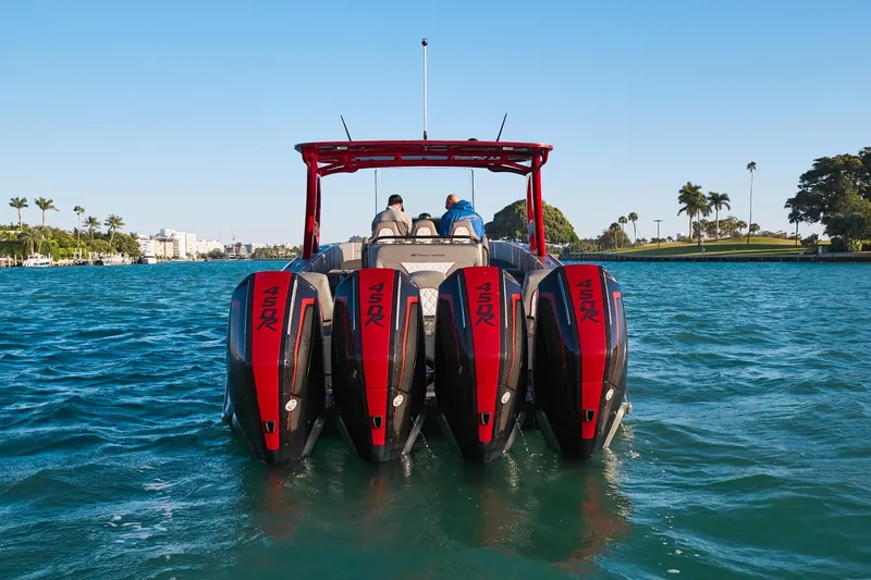 Slide: The Image of 2020 Midnight Express 37 Open boat with four powerful outboard engines on a sunny day. - 7