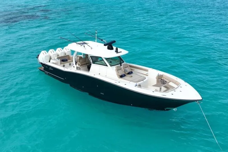 The Image of 2024 Scout 400 LXF boat on clear turquoise water, showcasing luxury and design. - 0