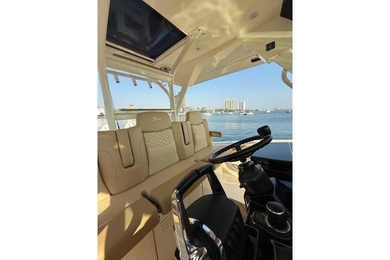 Slide: The Image of Luxurious interior of 2024 Scout 400 LXF boat with steering wheel and seating. - 10
