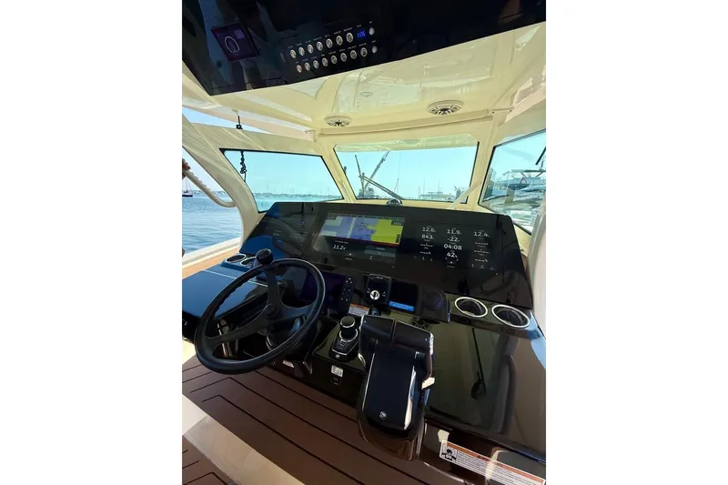 Slide: The Image of 2024 Scout 400 LXF boat dashboard with advanced navigation and control systems. - 11