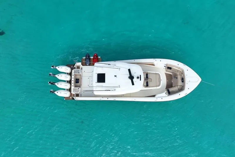 Slide: The Image of Aerial view of 2024 Scout 400 LXF boat on turquoise water. - 13