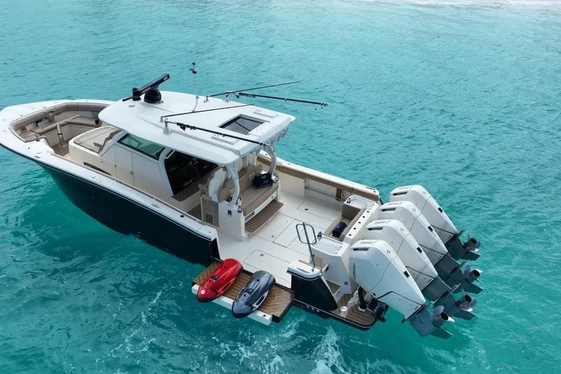 Slide: The Image of 2024 Scout 400 LXF boat with four engines on turquoise water. - 3