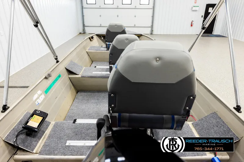 Slide: The Image of 1999 Tracker Pro Deep V-16 boat interior with seating and equipment in a garage setting. - 12