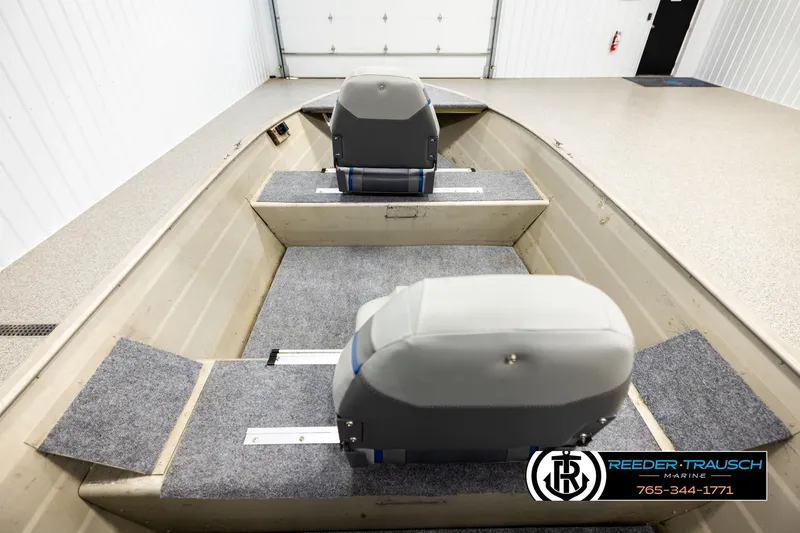 Slide: The Image of 1999 Tracker Pro Deep V-16 boat interior with two gray seats in a garage setting. - 13