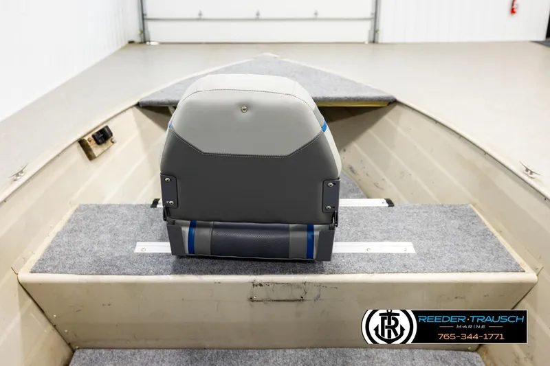 Slide: The Image of 1999 Tracker Pro Deep V-16 boat interior with gray seating and carpeted flooring. - 14