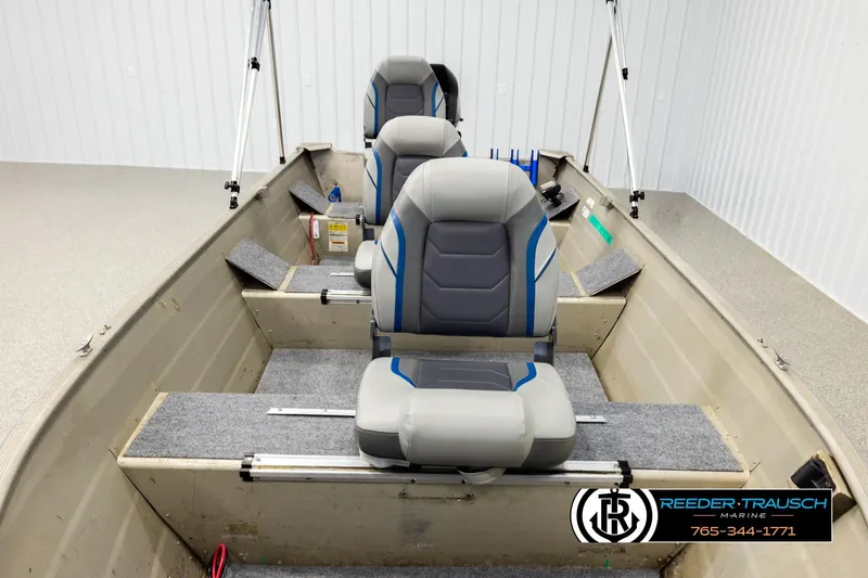 Slide: The Image of 1999 Tracker Pro Deep V-16 boat interior with gray seating and carpeted flooring. - 15