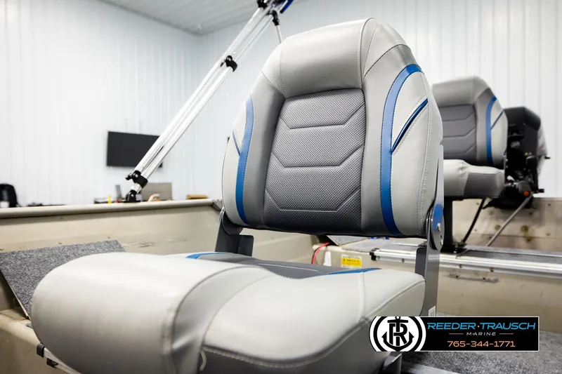 Slide: The Image of 1999 Tracker Pro Deep V-16 boat seat with blue and gray upholstery in a marine setting. - 21