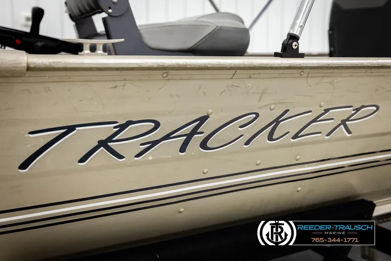 Slide: The Image of 1999 Tracker Pro Deep V-16 boat side view with logo and dealership details. - 26