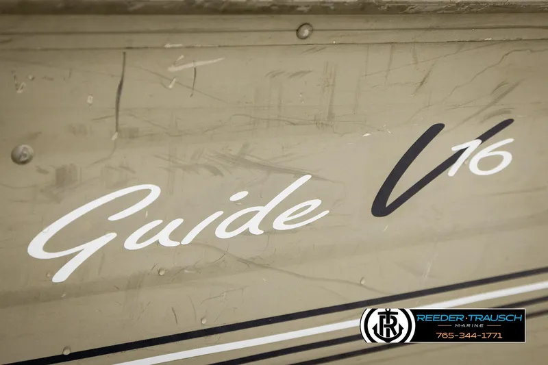 Slide: The Image of 1999 Tracker Pro Deep V-16 boat with "Guide V16" branding on the side. - 27