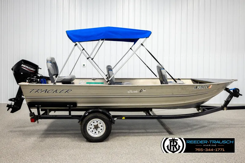 Slide: The Image of 1999 Tracker Pro Deep V-16 boat with blue canopy on trailer, side view. - 4
