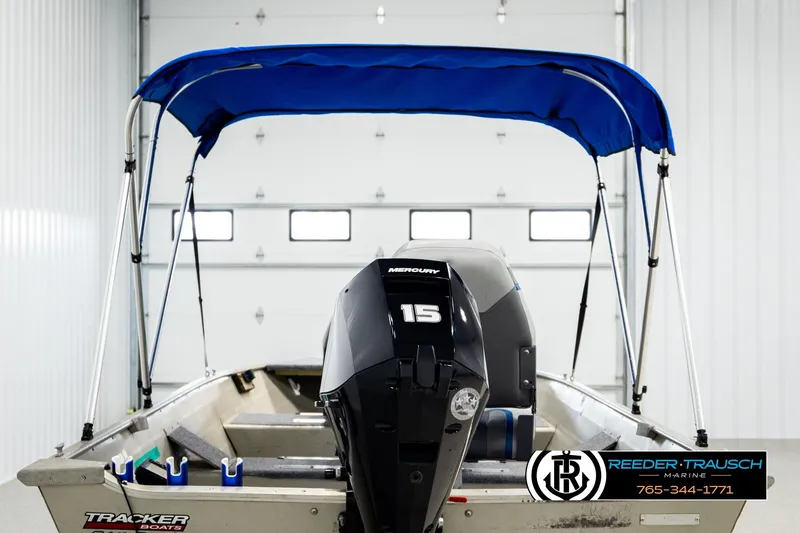 Slide: The Image of 1999 Tracker Pro Deep V-16 boat with Mercury 15 engine and blue canopy in a garage. - 6