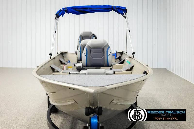 Slide: The Image of 1999 Tracker Pro Deep V-16 boat with blue canopy in showroom. - 7