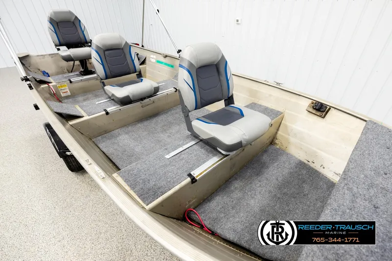 Slide: The Image of 1999 Tracker Pro Deep V-16 boat interior with three gray and blue seats. - 8