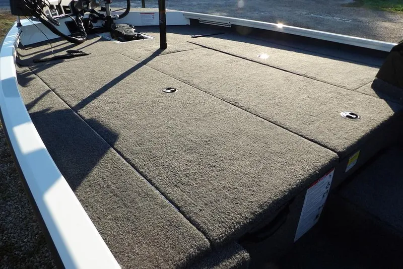 Slide: The Image of 2025 Crestliner XF 189 boat deck with carpeted surface and storage compartments. - 10