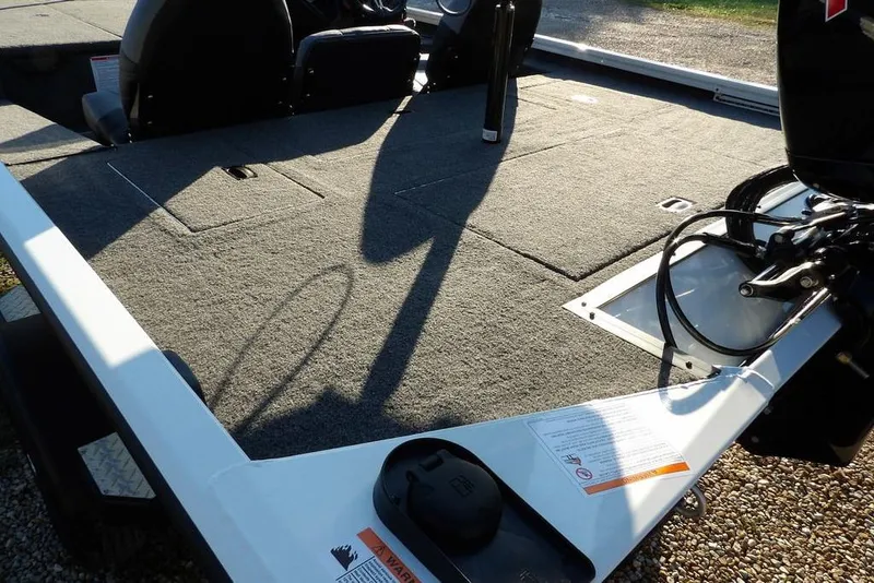 Slide: The Image of 2025 Crestliner XF 189 boat deck with carpeted surface and storage compartments. - 14