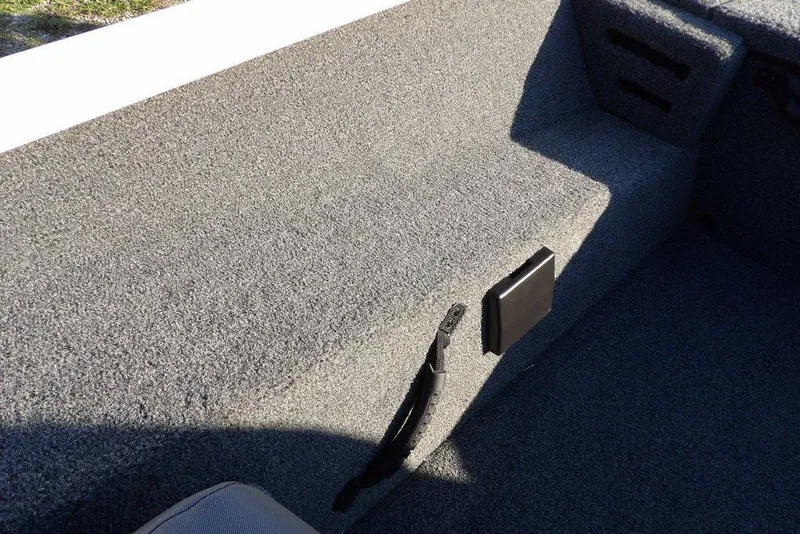 Slide: The Image of 2025 Crestliner XF 189 interior with gray carpeted flooring and storage compartments. - 26