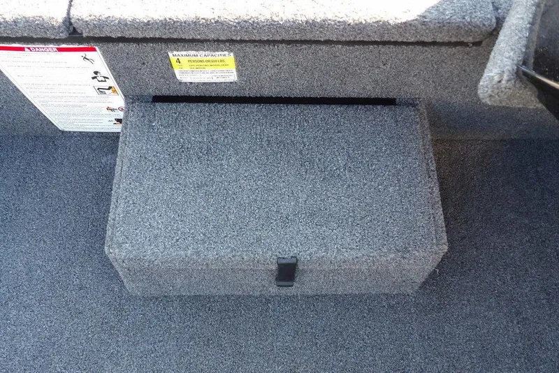 Slide: The Image of 2025 Crestliner XF 189 boat interior with carpeted storage compartment and safety labels. - 28