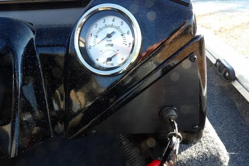 Slide: The Image of 2025 Crestliner XF 189 dashboard with RPM gauge and ignition key. - 30