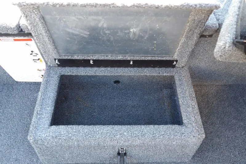 Slide: The Image of Open storage compartment in 2025 Crestliner XF 189 boat, featuring gray carpeted interior. - 34