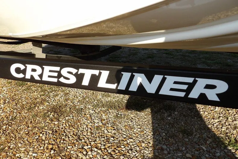 Slide: The Image of Crestliner XF 189 boat trailer, 2025 model, on gravel surface. - 48