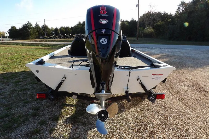Slide: The Image of 2025 Crestliner XF 189 boat with powerful outboard motor on a gravel path. - 5
