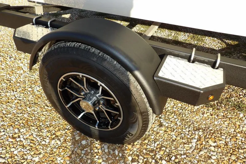Slide: The Image of 2025 Crestliner XF 189 trailer wheel with black fender and diamond plate step. - 50