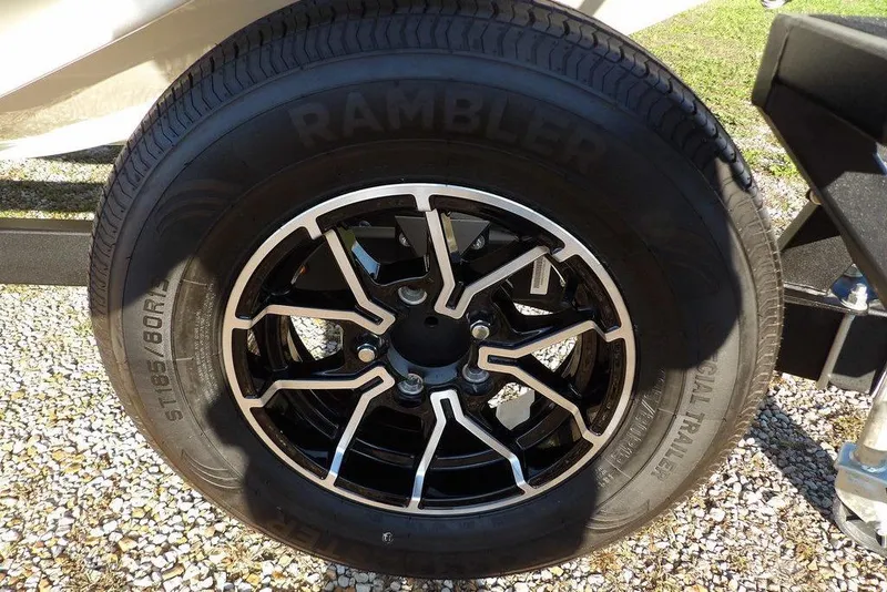 Slide: The Image of 2025 Crestliner XF 189 trailer wheel with black and silver alloy rim design. - 51