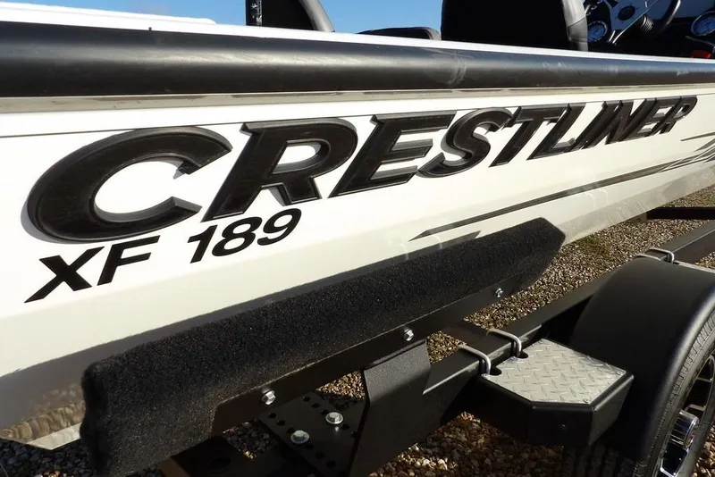 Slide: The Image of 2025 Crestliner XF 189 boat side view with logo and trailer. - 52