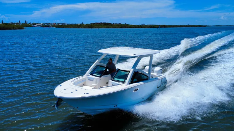 Slide: The Image of 2025 Robalo R257 Dual Console boat cruising on a sunny day. - 11