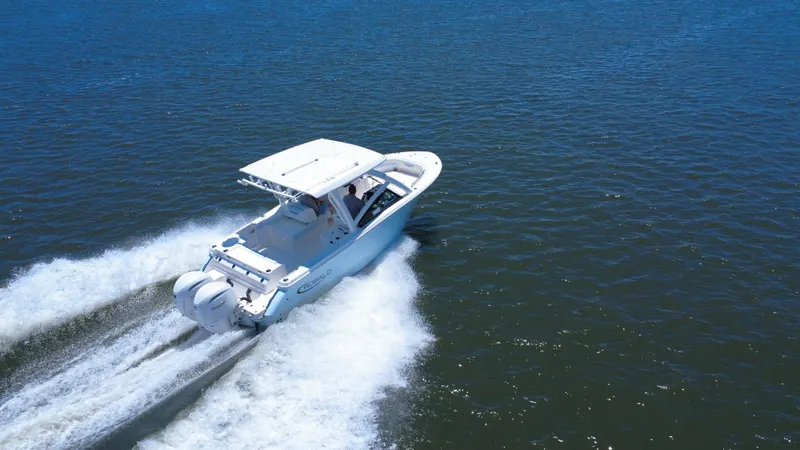 Slide: The Image of 2025 Robalo R257 Dual Console boat cruising on open water. - 14