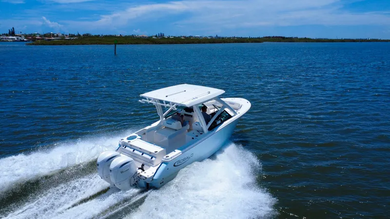 Slide: The Image of 2025 Robalo R257 Dual Console cruising on open water under clear skies. - 15