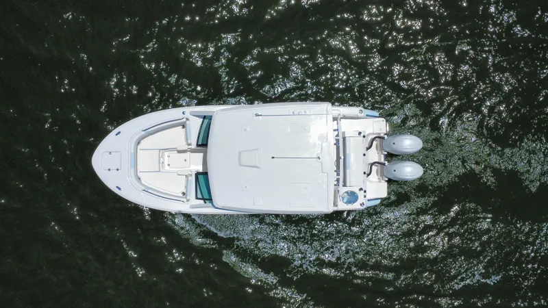 Slide: The Image of Overhead view of 2025 Robalo R257 Dual Console boat on water. - 16