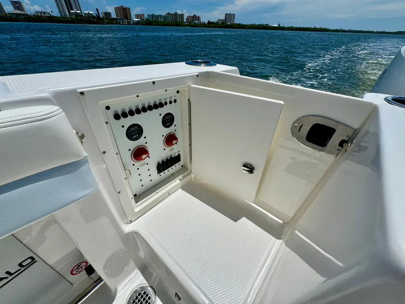 Slide: The Image of 2025 Robalo R257 Dual Console boat control panel with scenic water view. - 17